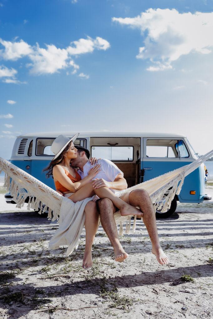 couple snuggling in a hammok on the beach for their tampa elopement