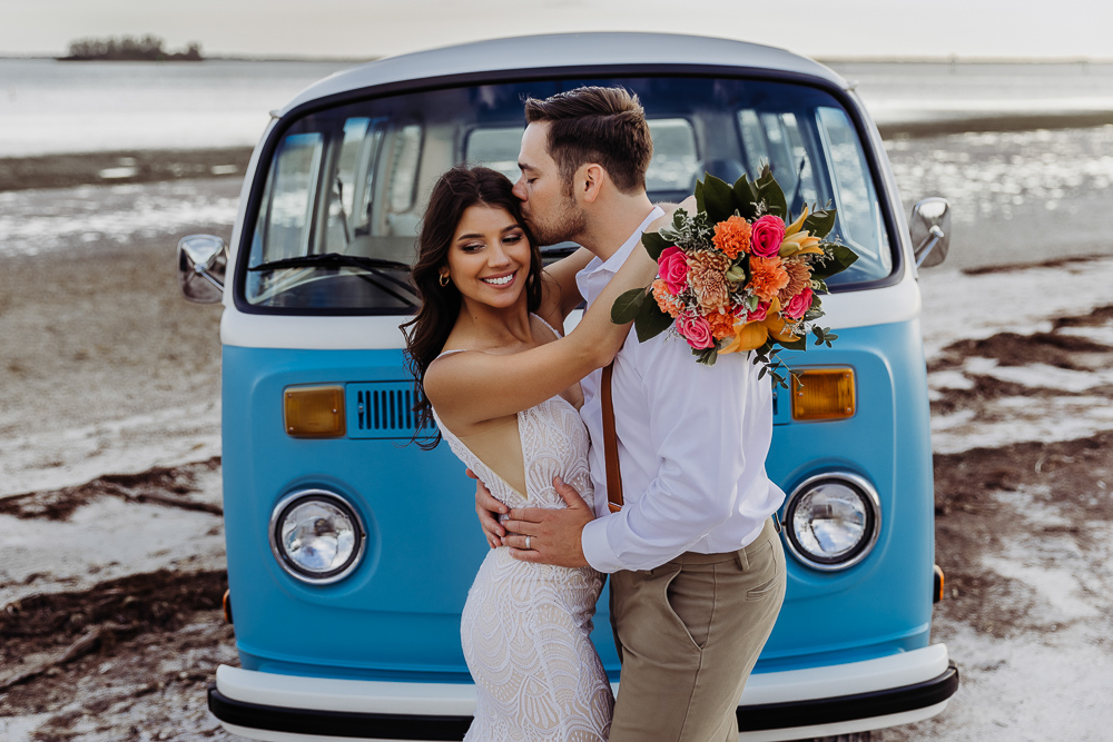 newly weds kissing in front of vw van after eloping in tampa florida
