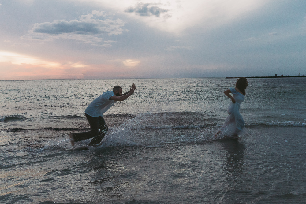 couple splashing in the ocean in sarasota florida