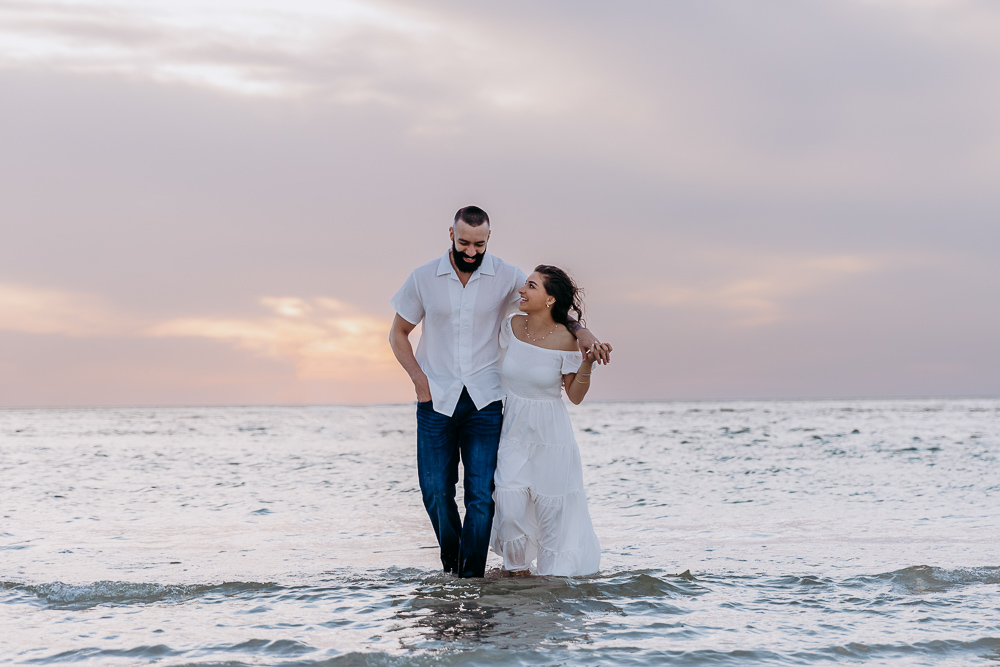 couple hugging playfully on the anna maria island outside sarasota