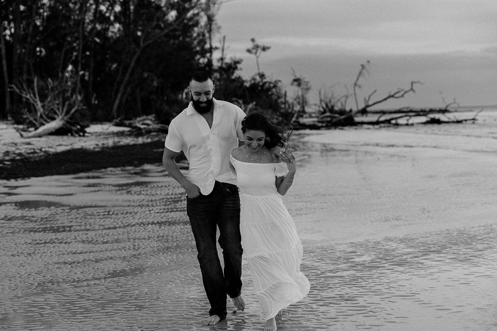 couple embracing on the beach on anna maria island outside of sarasota florida