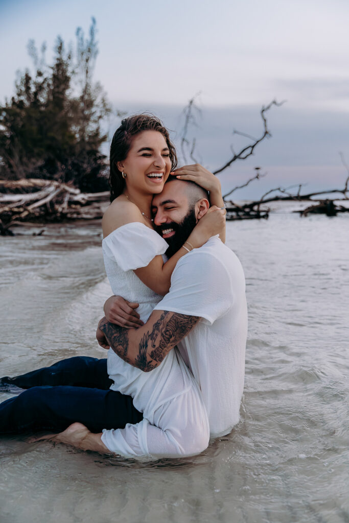 newly engaged couple laughing on long boat key florida 