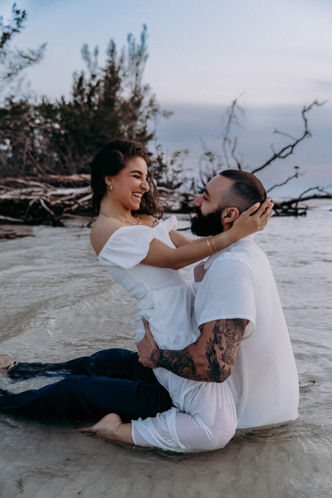 couple laughing in the ocean on the beach