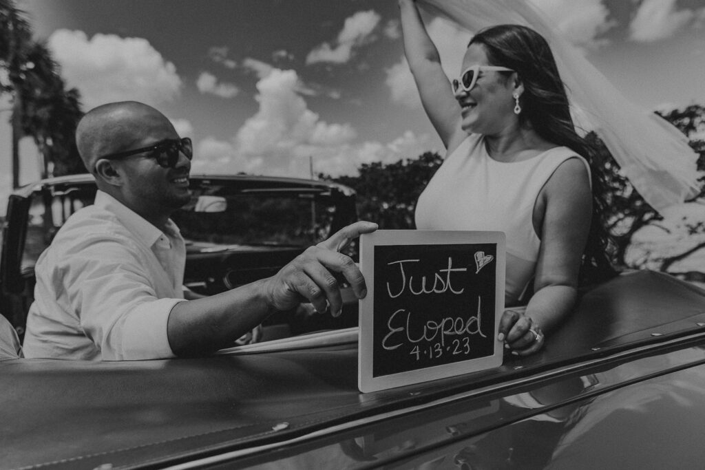 tampa elopement photographer taking a photo of couple in vintage mustang