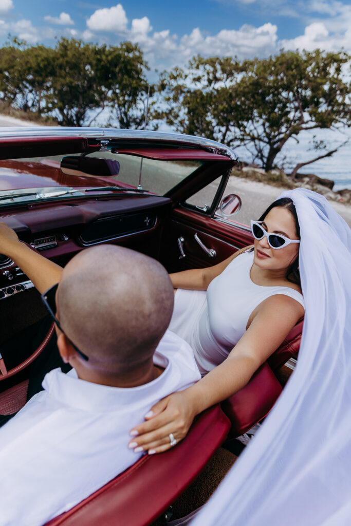 tampa elopement photographer taking a photo of couple in vintage mustang