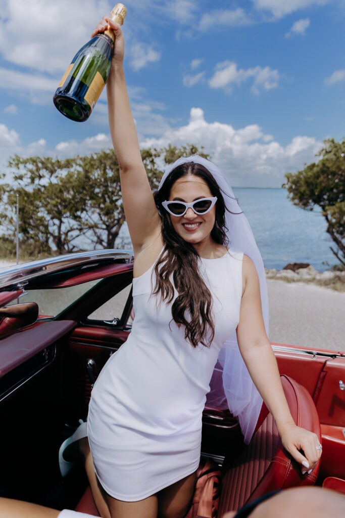 bride celebrating with champagne after eloping 