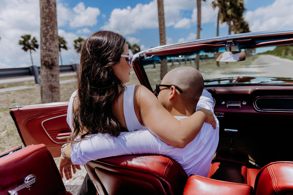 tampa elopement photographer taking a photo of couple in vintage mustang