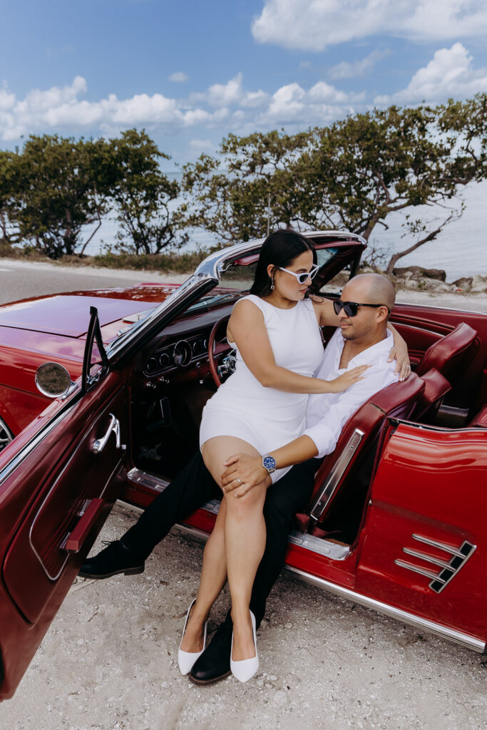 tampa elopement photographer taking a photo of couple in vintage mustang