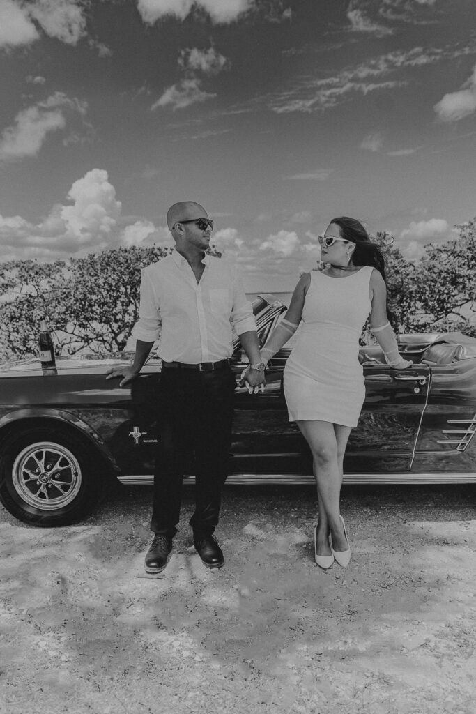 tampa elopement photographer taking a photo of couple in vintage mustang