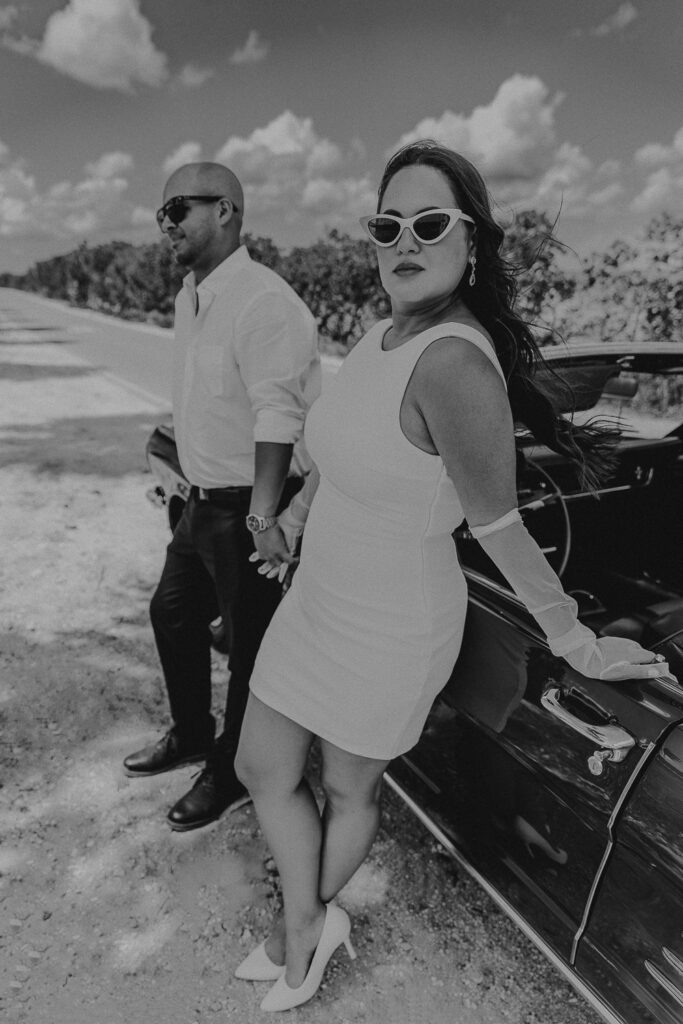 tampa elopement photographer taking a photo of couple in vintage mustang