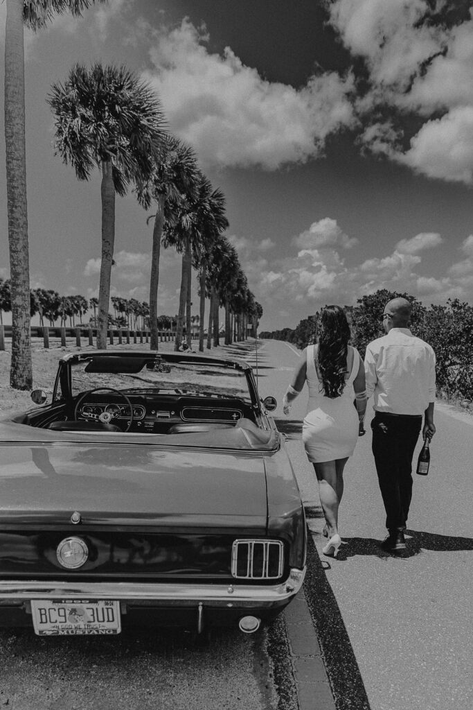 tampa elopement photographer taking a photo of couple in vintage mustang