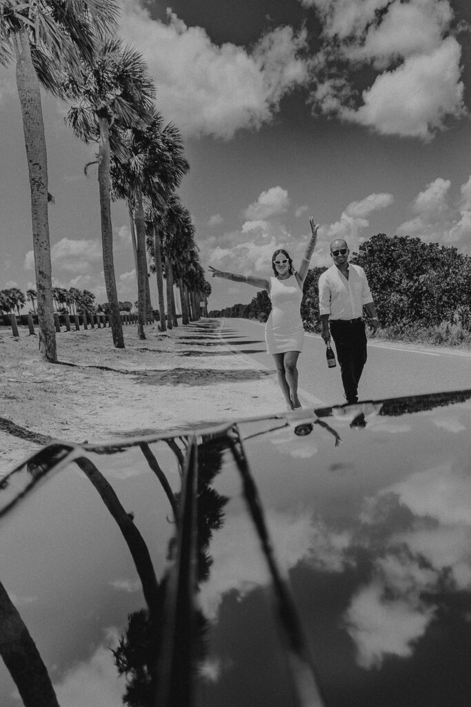 tampa elopement photographer taking a photo of couple in vintage mustang