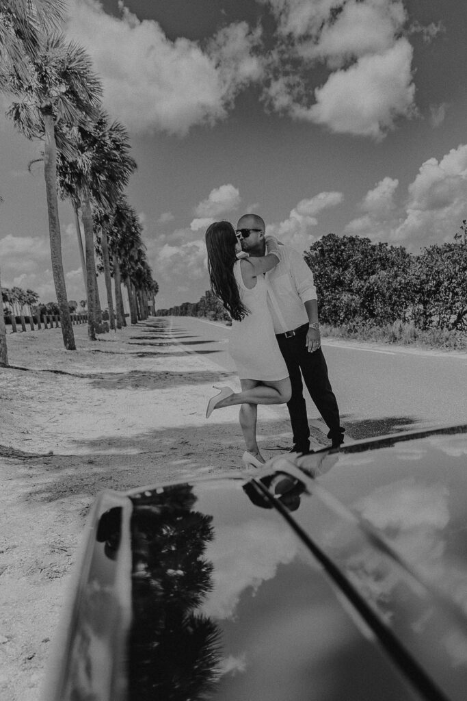 tampa elopement photographer taking a photo of couple in vintage mustang