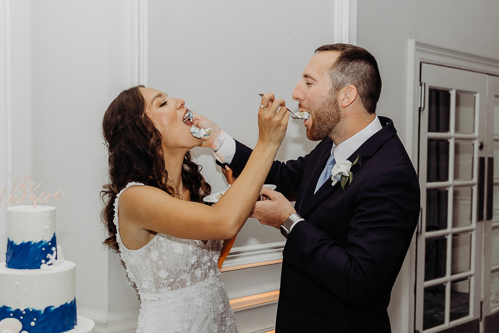 bride and groom cutting their wedding cake at their wedding reception