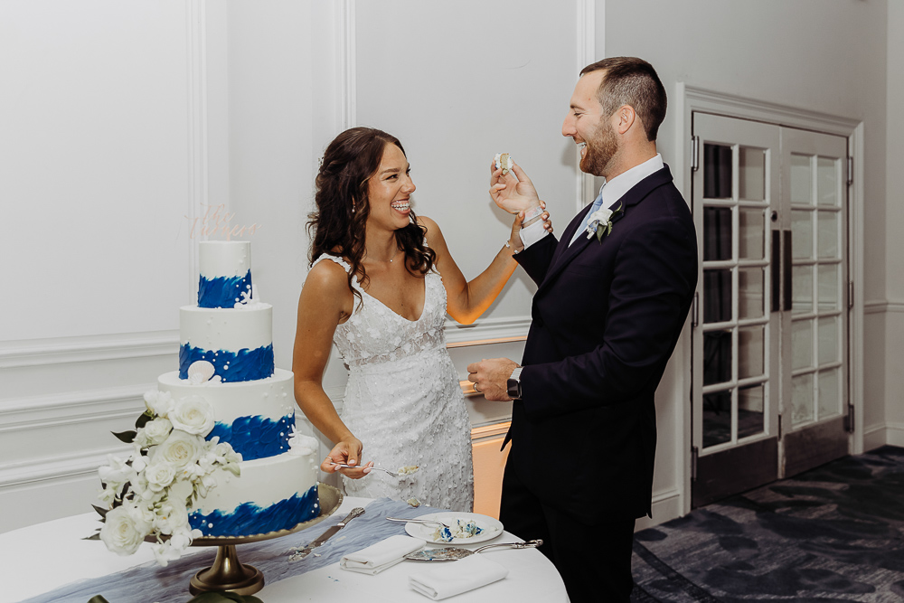 bride and groom cutting their wedding cake at their wedding reception