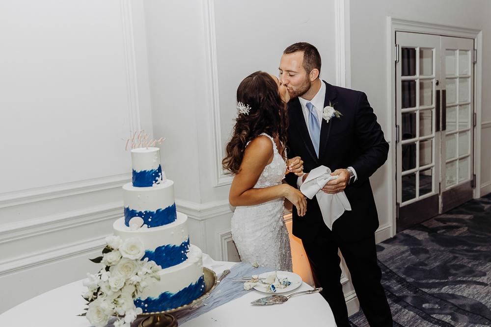 bride and groom cutting their wedding cake at their wedding reception