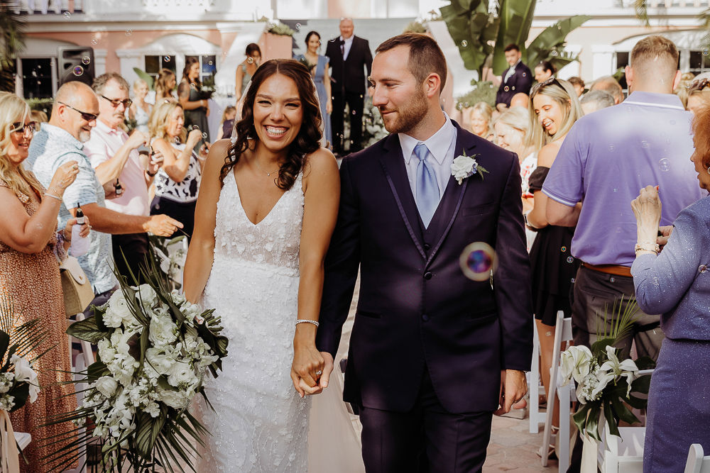 bride and groom walking down aisle for their don cesar wedding