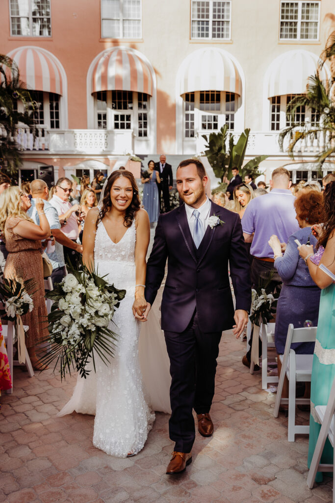 bride and groom walking down the aisle at their don cesar wedding in st pete florida