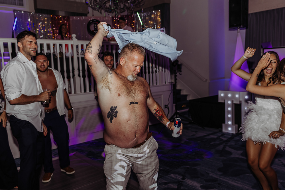 reception photo of man dancing shirtless at the don cesar