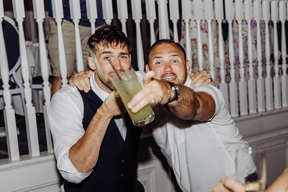 reception photo of two guys singing 