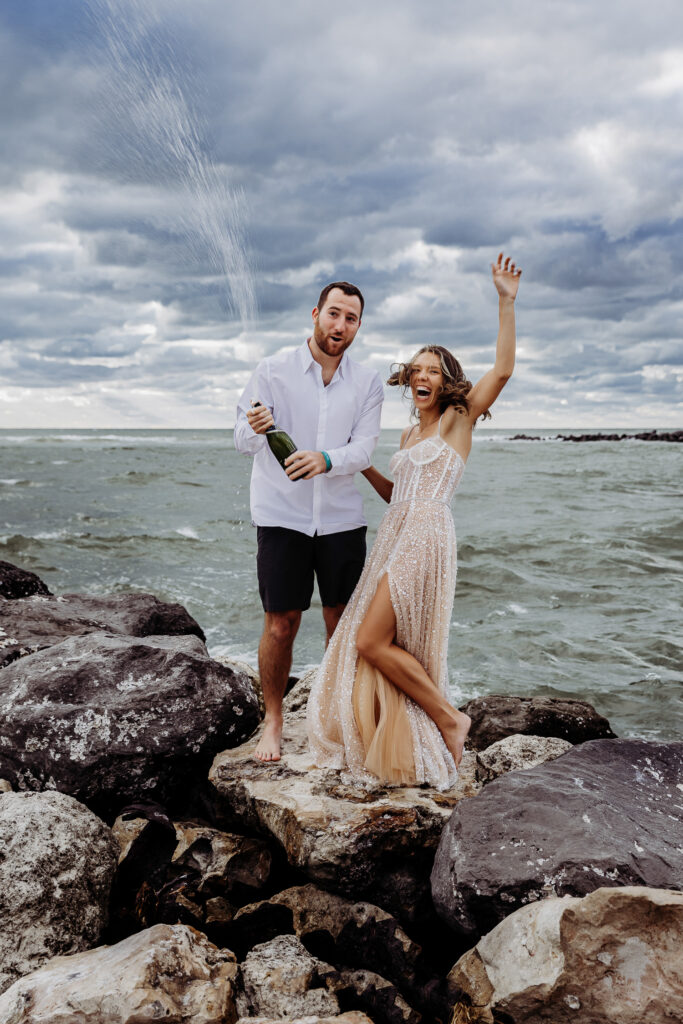 couple popping champagne that they remembered to bring from their elopement checklist