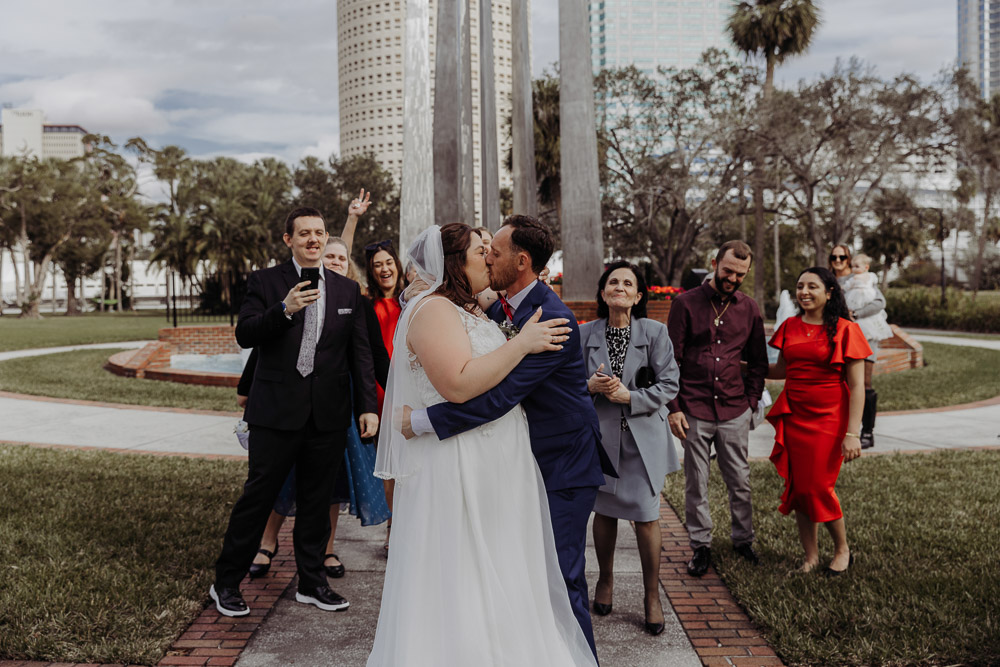 couple kiss after saying I do for their florida elopement in plant park tampa 