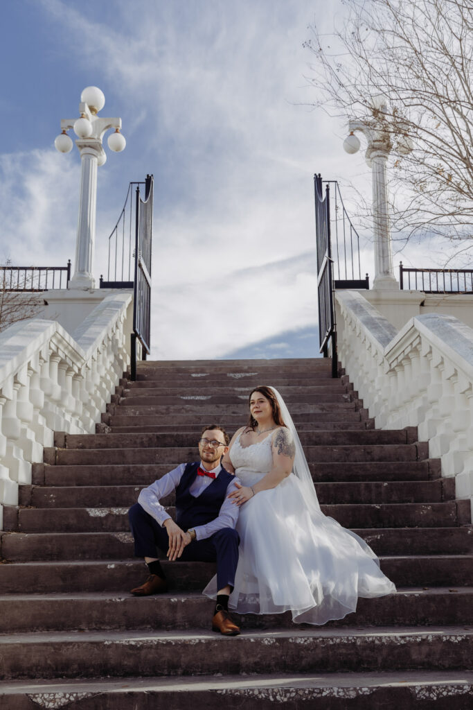 couple taking portraits on stairs after their elopement 