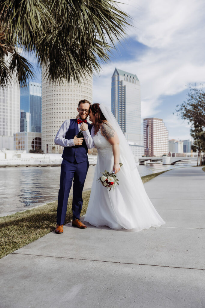 couple laughing during their champagne pop post elopement in plant park tampa
