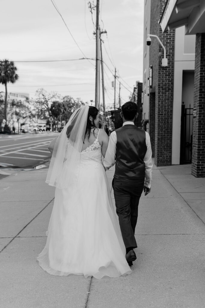 couple walking down to the bar post elopement