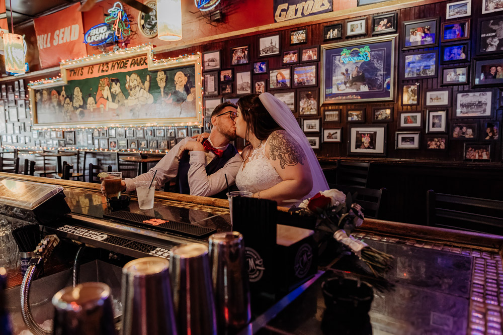 couple sharing a kiss at the bar they had their first date at 