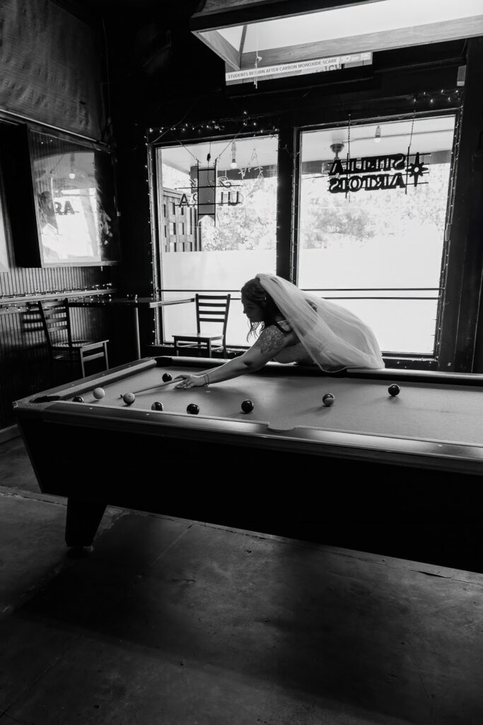 bride playing pool after eloping 