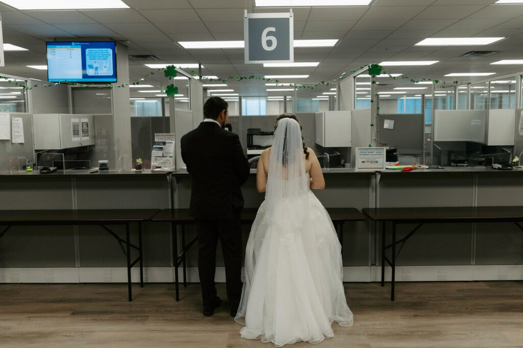couple looking over paperwork at the courthouse for their tampa elopement