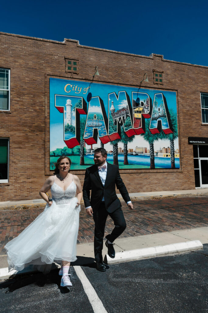 couple in front of tampa post card walking together 