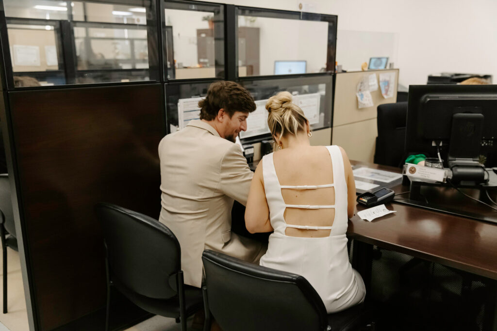 couple signing paperwork for their courthouse elopement in tampa 