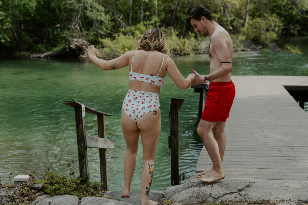 couple going swimming after their courthouse elopement 