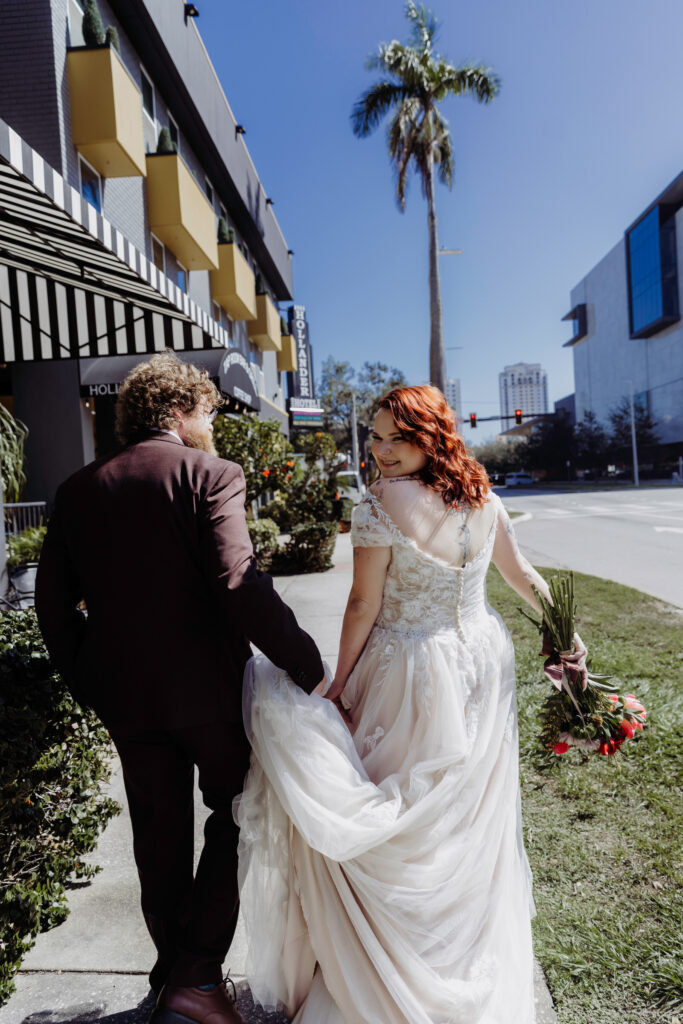 couple walking together down the street after just getting married 