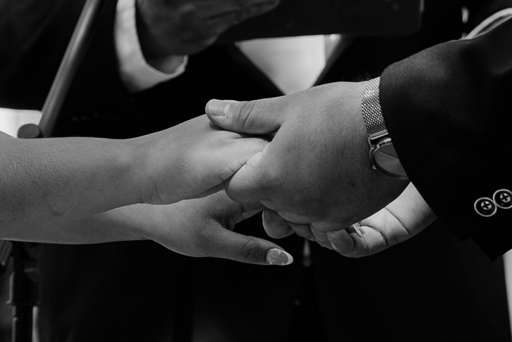 picture of couples hands at the alter having their intimate wedding in tampa at davis island garden club