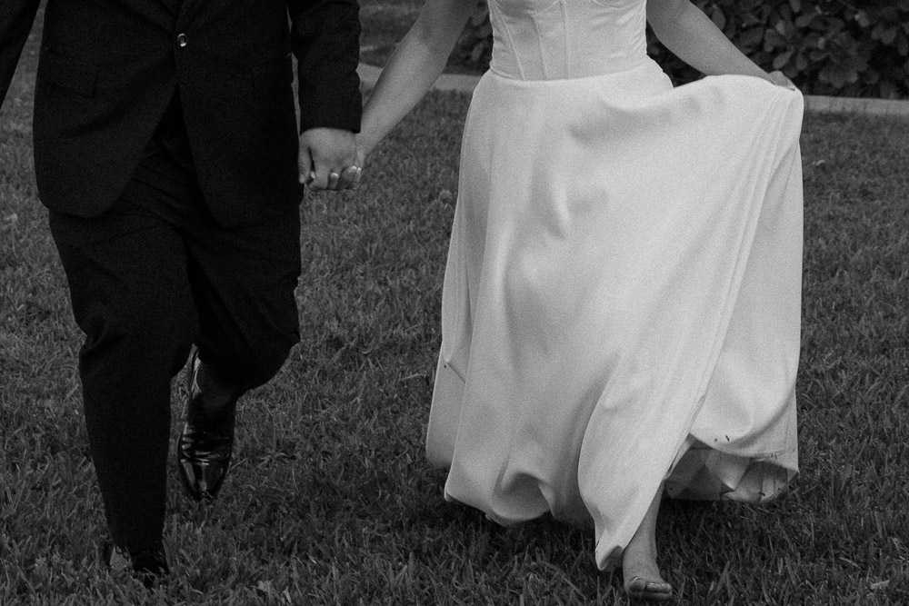 picture of couple running after their intimate wedding at davis island garden club in tampa