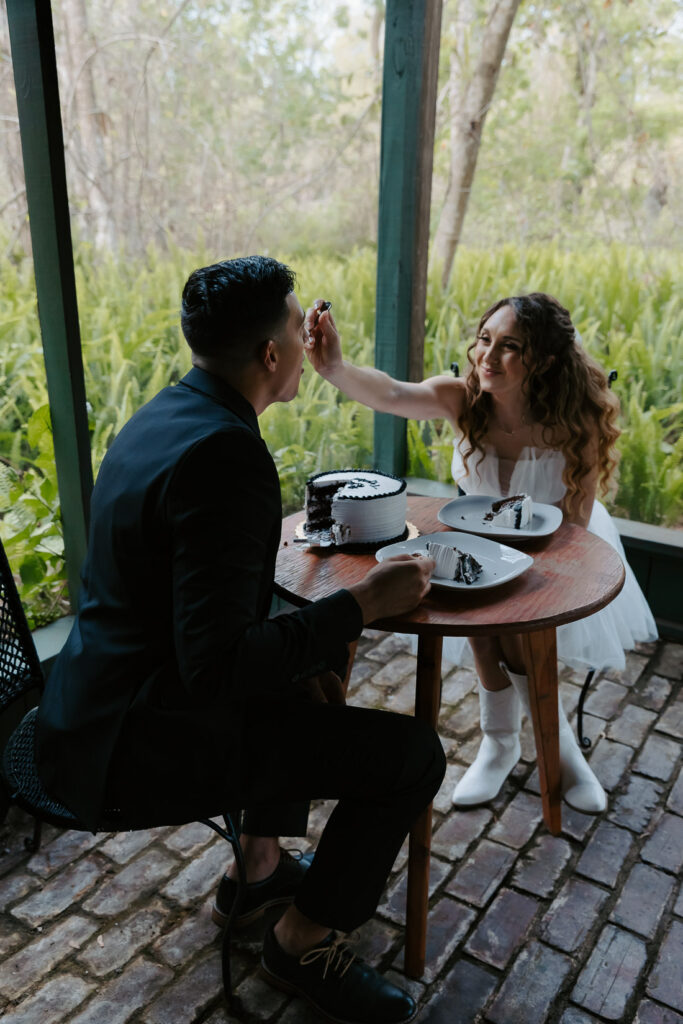 couple eating caking after getting eloped in florida
