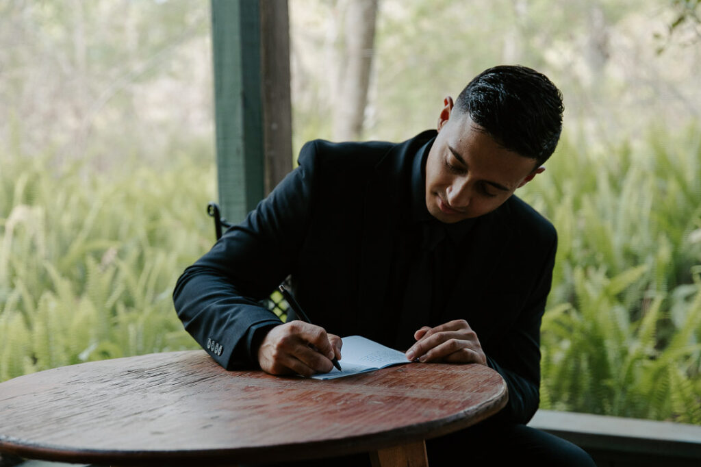 groom writing vows before his elopement in florida
