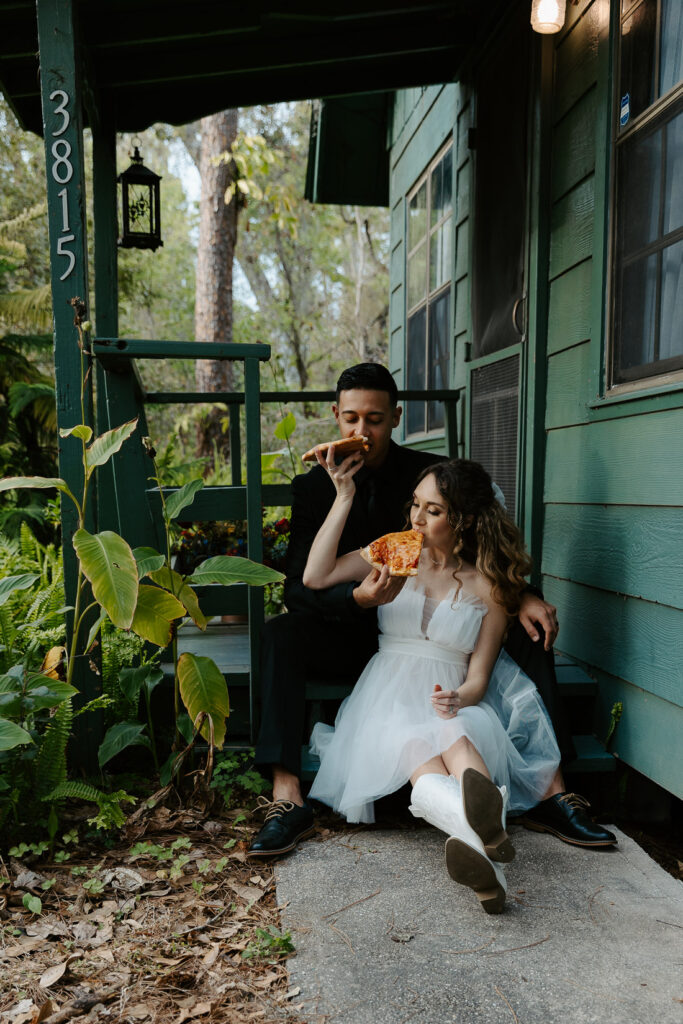 couple sharing pizza after their elopement in a cabin in tampa