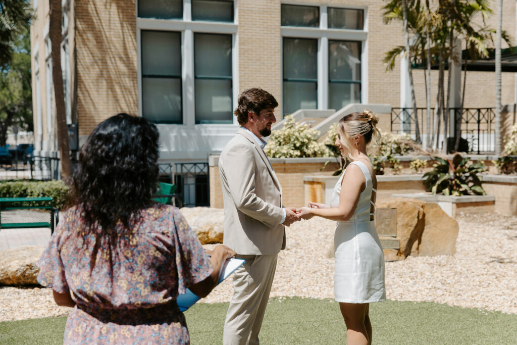 couple facing each other outside the courthouse in clearwater for their wedding ceremony 