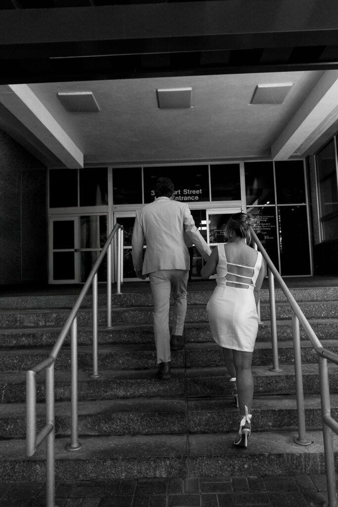 couple walking into the clearwater courthouse for their florida elopement