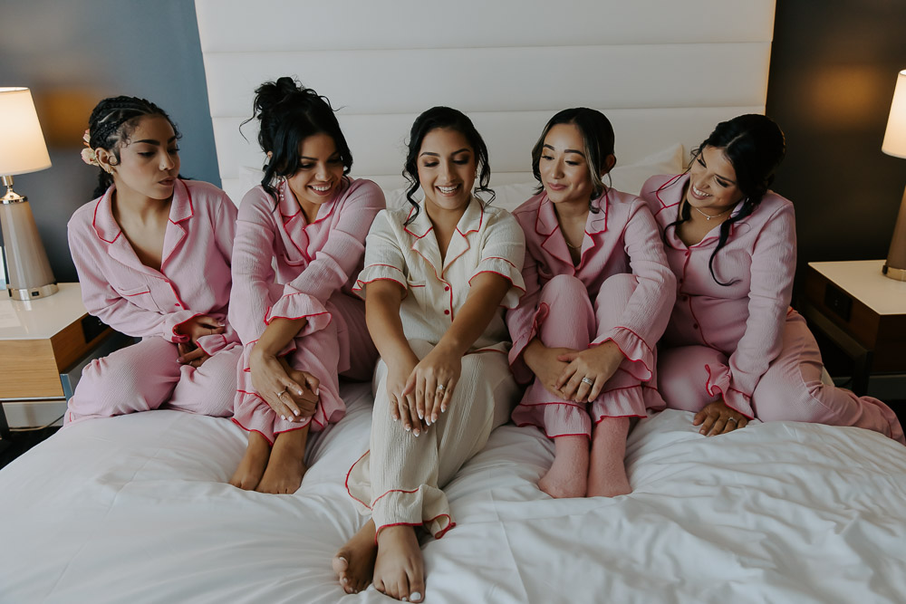 hotel photos of the bridesmaids with the bride having fun in matching pjs