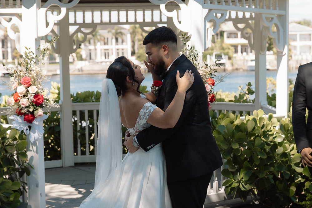 bride and groom share their first kiss 