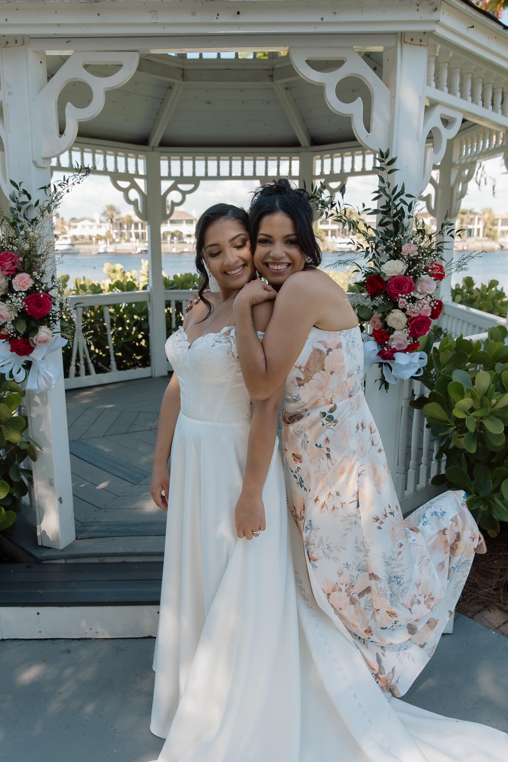bride takes a photo with her sister after the wedding ceremony 