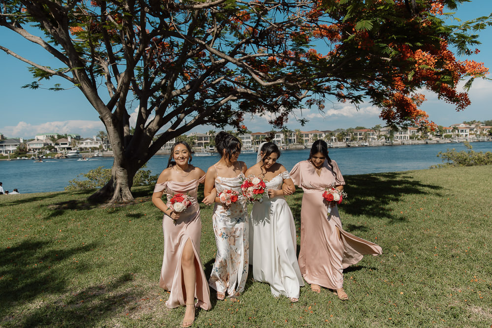 fun photo of all the bridesmaids walking together along the riverwalk 