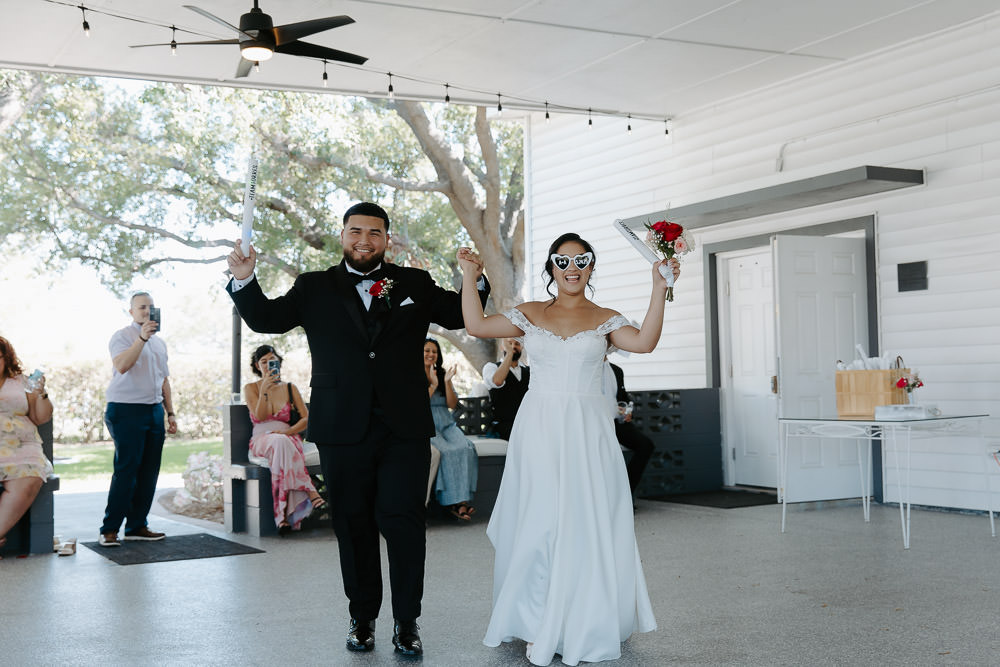 bride and groom enter the reception space dancing and smiling at their davis island garden club wedding 