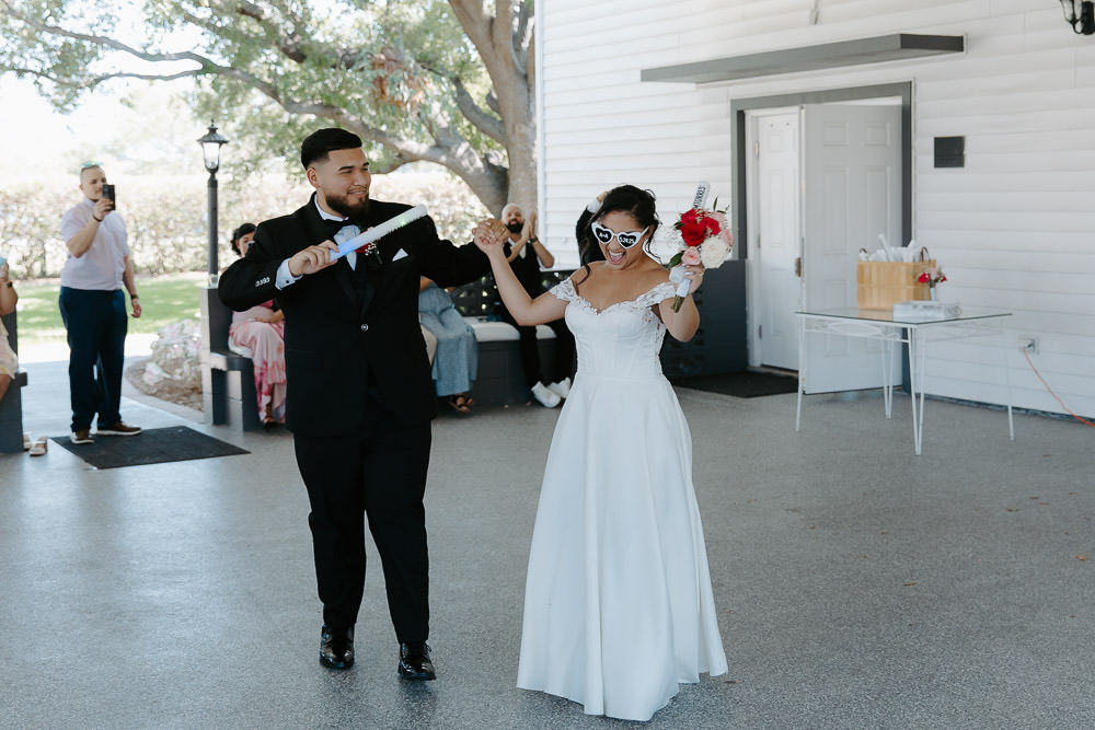 bride and groom enter the reception space dancing and smiling at their davis island garden club wedding 