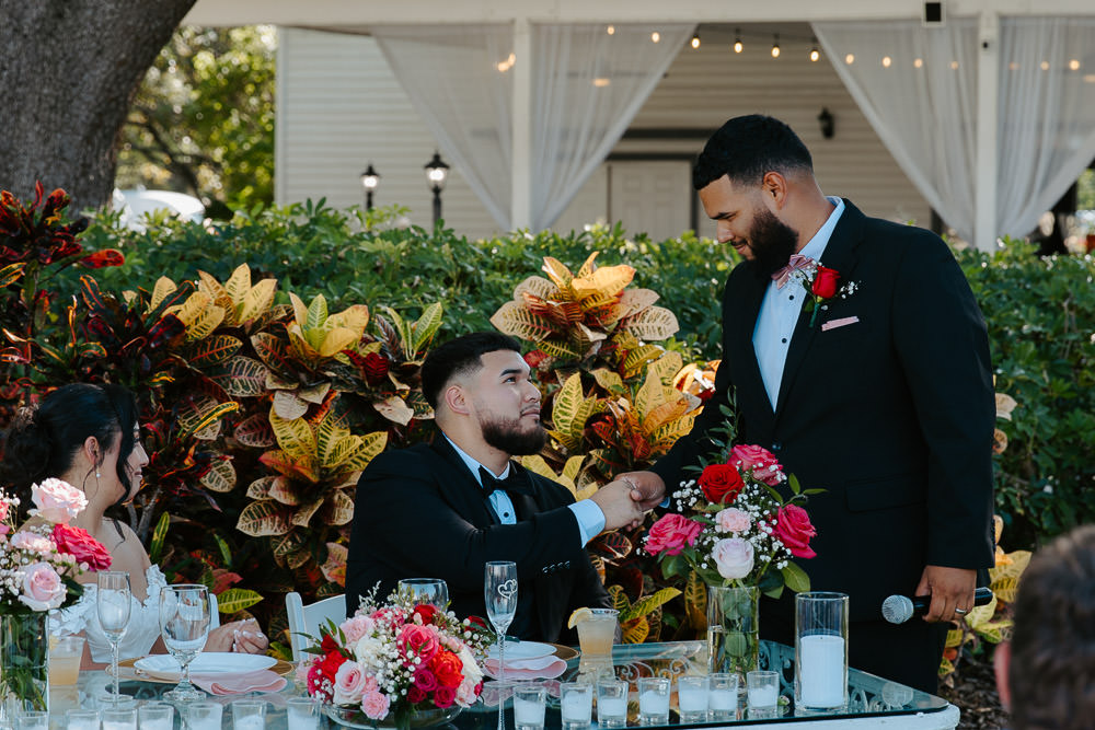 best man and grrom shake hands after his speech 